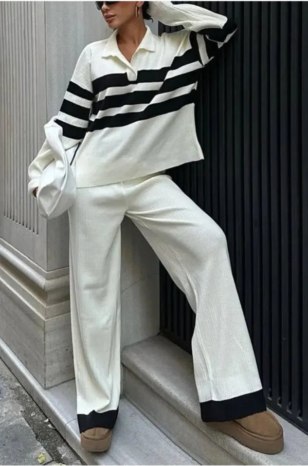 Women's black and white striped knitted polo shirt with matching trousers, a casual two-piece set.