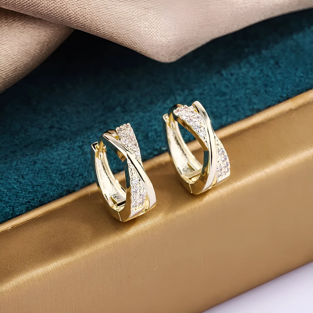 A pair of geometric earrings in 14K yellow colour, made from copper with a zircon treatment.