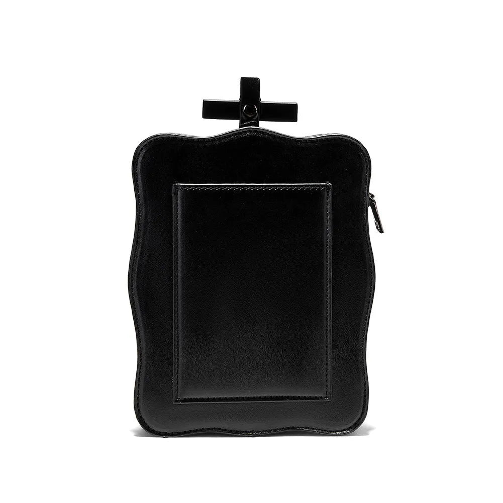 Black mini square crossbody bag with detailed skull embossing, rivets, and a shoulder strap.
