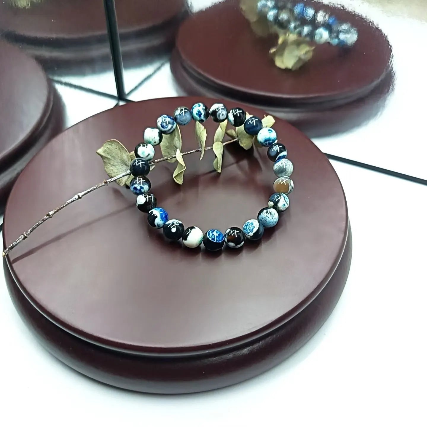 Handmade bohemian bracelet with natural agate and coloured glass beads on a wrist.