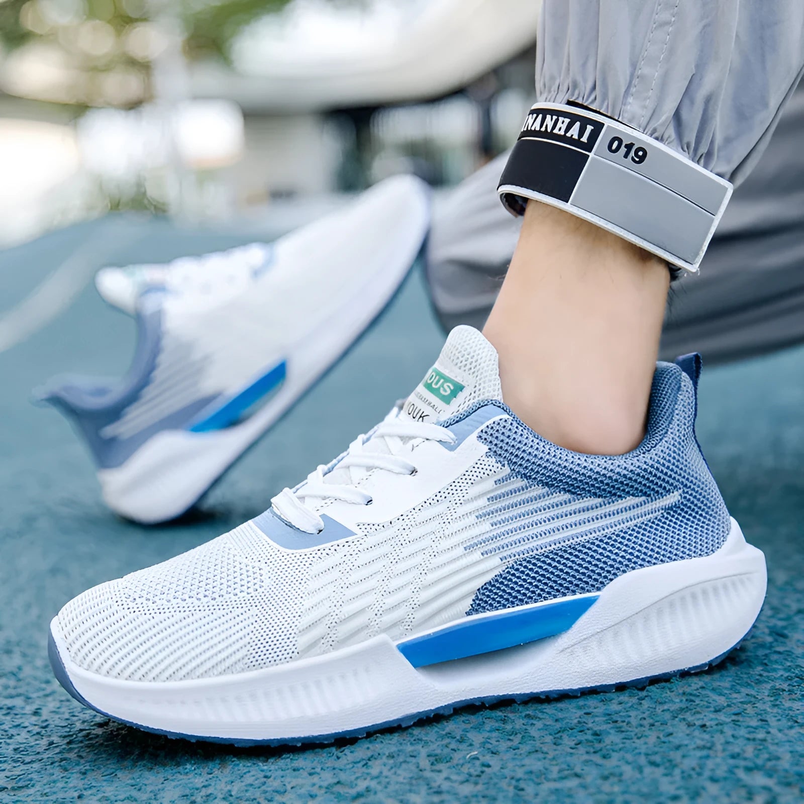 Blue men's casual mesh sports shoes with a round toe and plastic sole, shown on a white background.