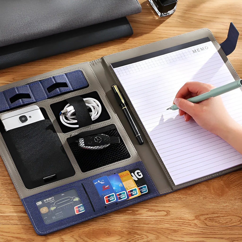 Black leather A4 business folder open to show pen loop, notepad holder, and rigid construction.