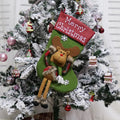 Three large Christmas stockings with Santa, Snowman, and Reindeer 3D applique designs hanging from a mantel
