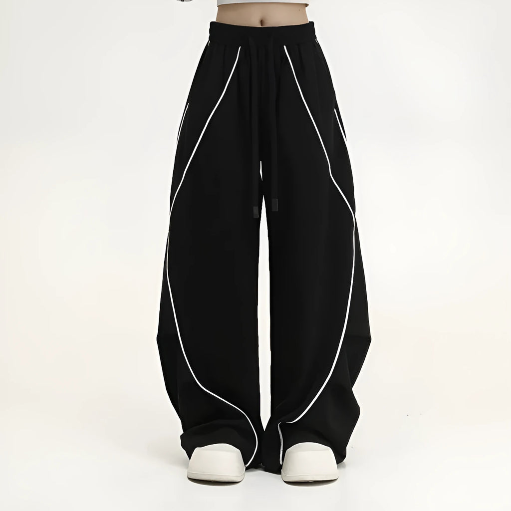 Black striped pleated wide-leg hip hop trousers on hanger showing mid-waist design