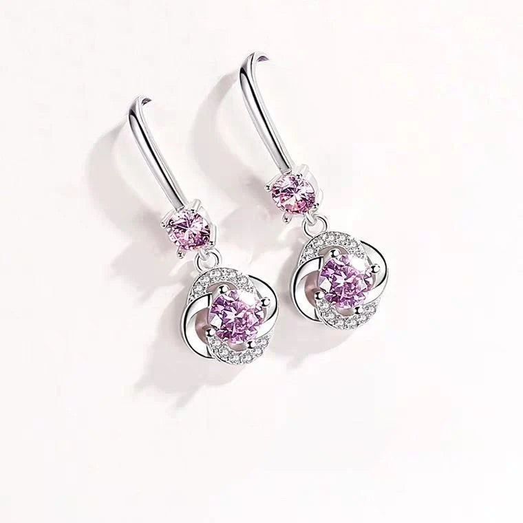 Silver four-leaf clover stud earrings with fairy hooks, symbolising happiness