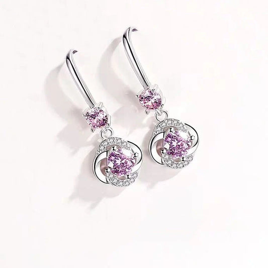 Silver four-leaf clover stud earrings with fairy hooks, symbolising happiness