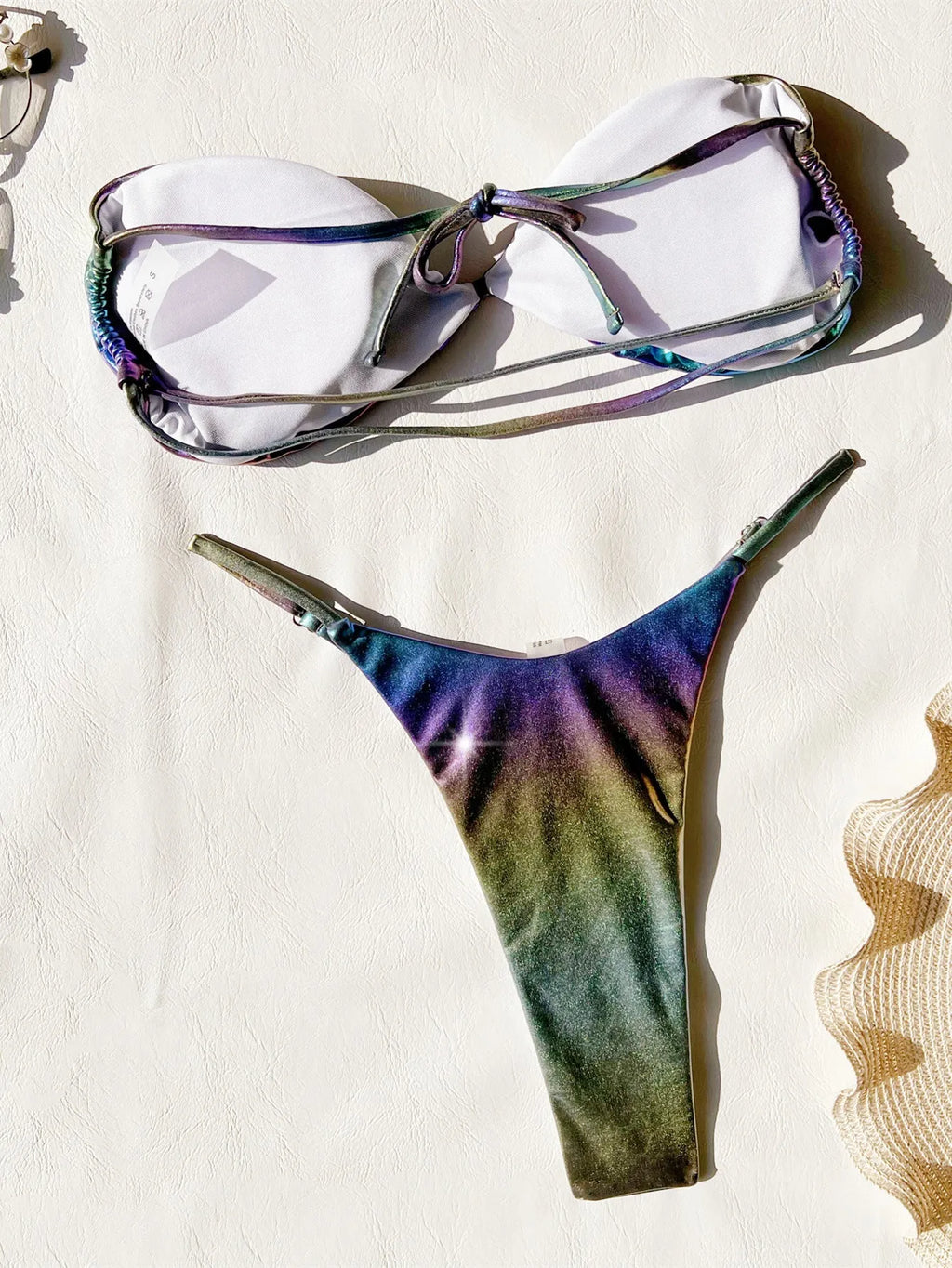 Women's gradient purple polyester bikini swimsuit laid flat, showing top and bottom.