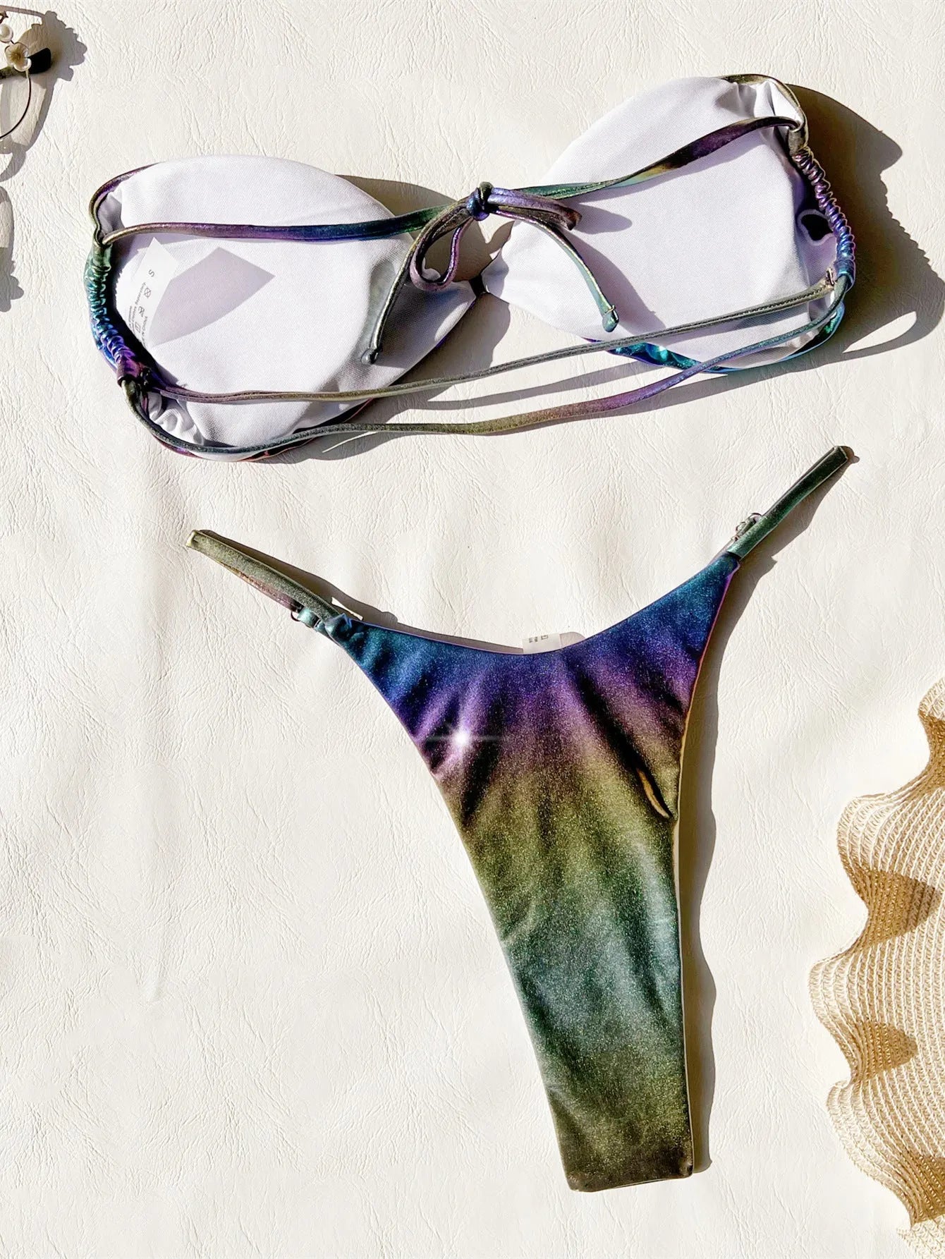 Women's gradient purple polyester bikini swimsuit laid flat, showing top and bottom.