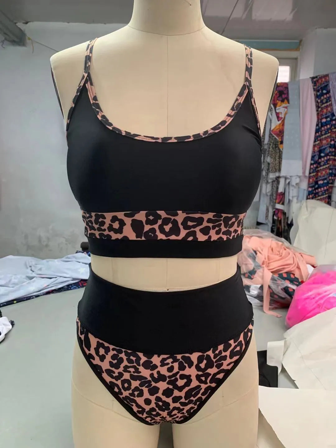 Women's white and leopard print high waist split bikini swimsuit with adjustable ties laid flat