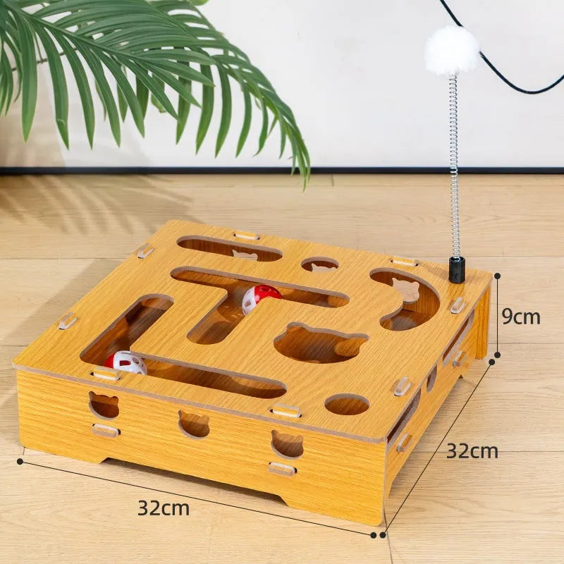 Wooden cat maze box with teasing stick and two bell balls on a floor