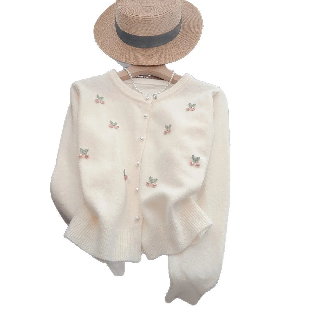 Women's soft pink cashmere blend cardigan coat with beaded detail and round neck, laid flat.