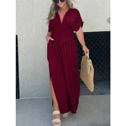 Stylish summer dress featuring unique bat sleeves, v-neck, slit design, and elastic waist for a flattering fit