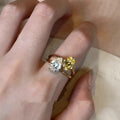 Copper geometric open ring with water drop design and two small set stones on a white background.