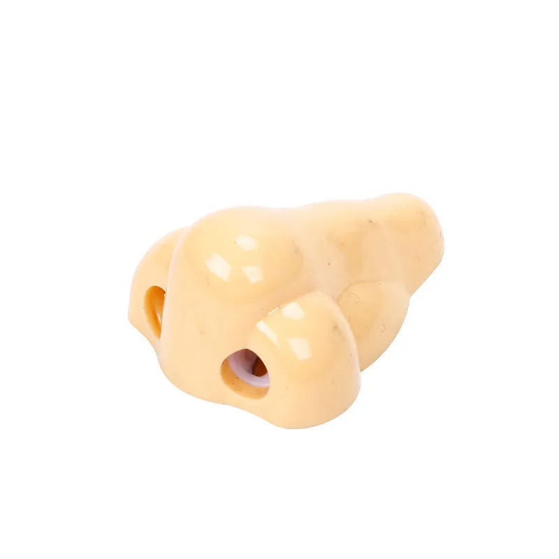 Flesh-coloured geometry-shaped plastic pencil sharpener with big nostril for standard pencils.