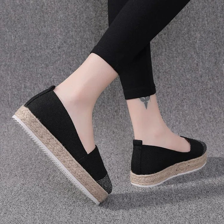 Black plus size breathable canvas flat shoe with round toe and slip-on design.