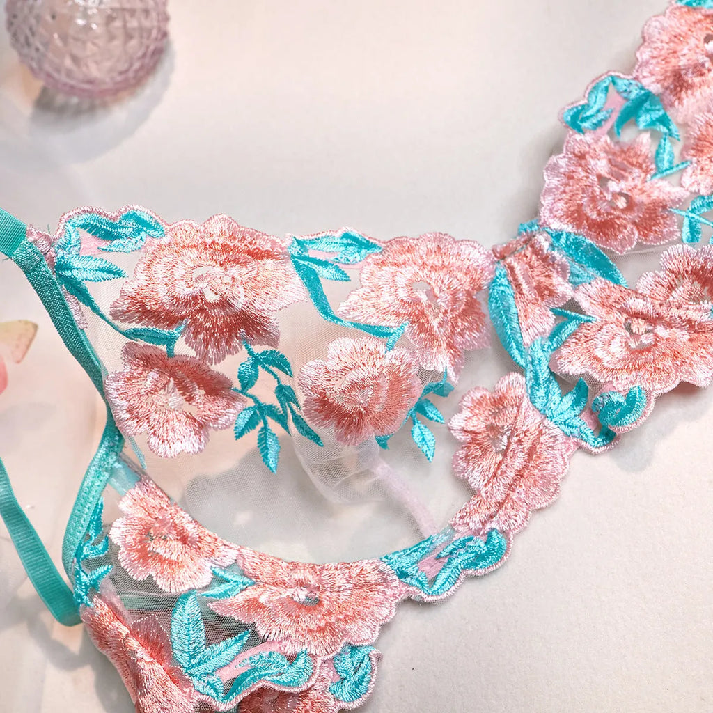 Pink women's bikini set with embroidery detail and a matching sheer mesh pettiskirt skirt.