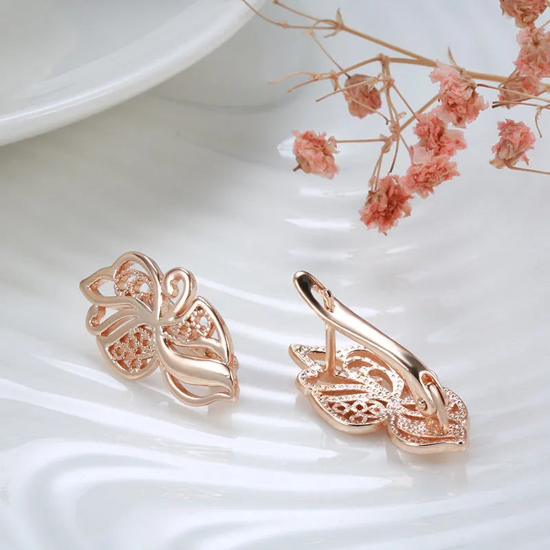 Women's rose gold earrings with hollow carved geometric design and rhinestone accents