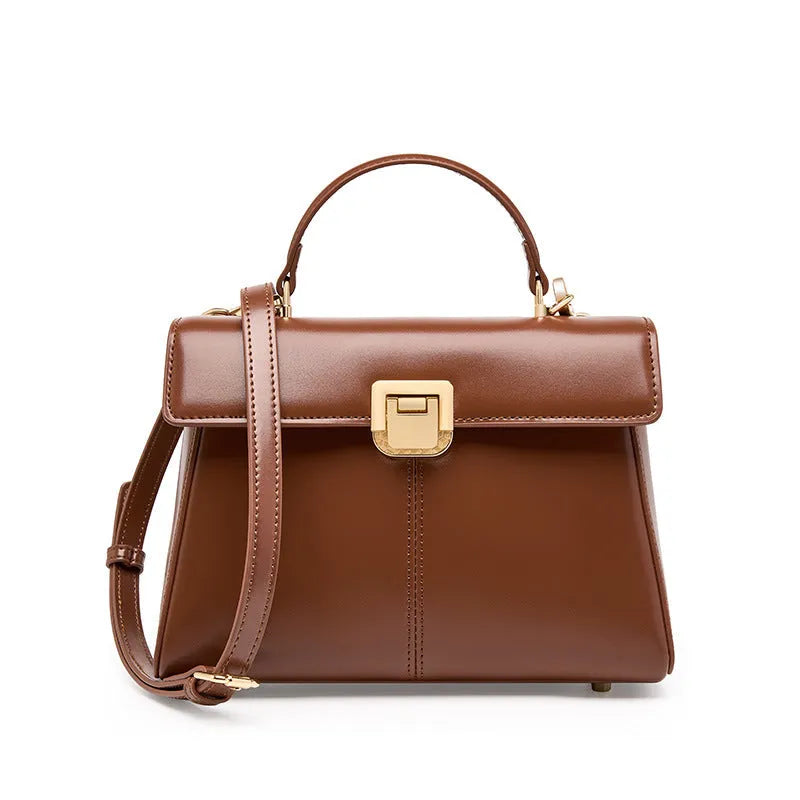 Black genuine leather women's shoulder bag with vachette clasp and long strap.