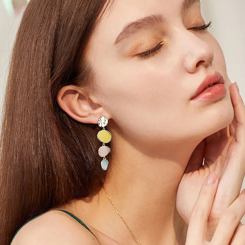 A pair of simple disc-shaped alloy earrings with a Morandi colour oil-drip finish on a sterling silver post.