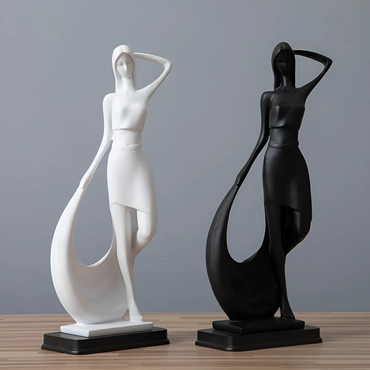Resin abstract smart dancer sculpture in sub-white finish on a shelf, modern home decoration
