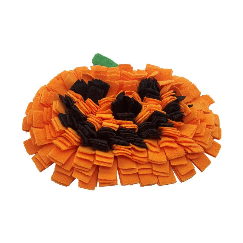 Orange pumpkin-shaped dog slow feeder mat with fleece texture on wooden floor