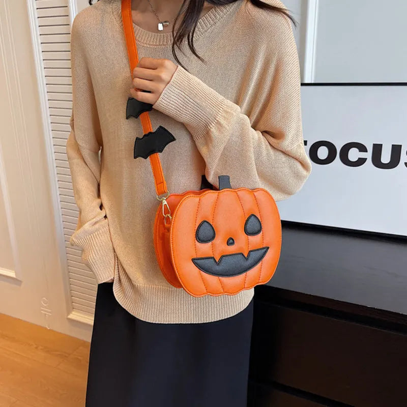 Horizontal view of a PU crossbody bag with pumpkin and bat cartoon design in orange colour option.