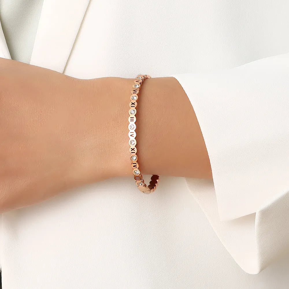 Korean style titanium steel bracelet with an adjustable number charm in gold, rose gold, or steel colour.