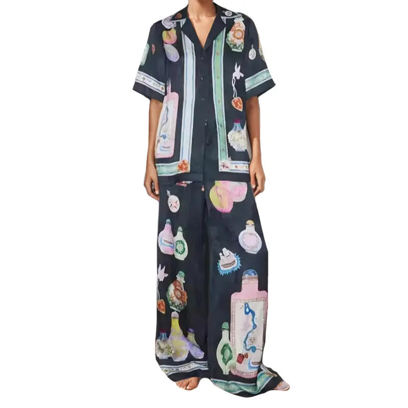 Black women's casual set with cartoon print, featuring a top with regular sleeves and matching trousers.