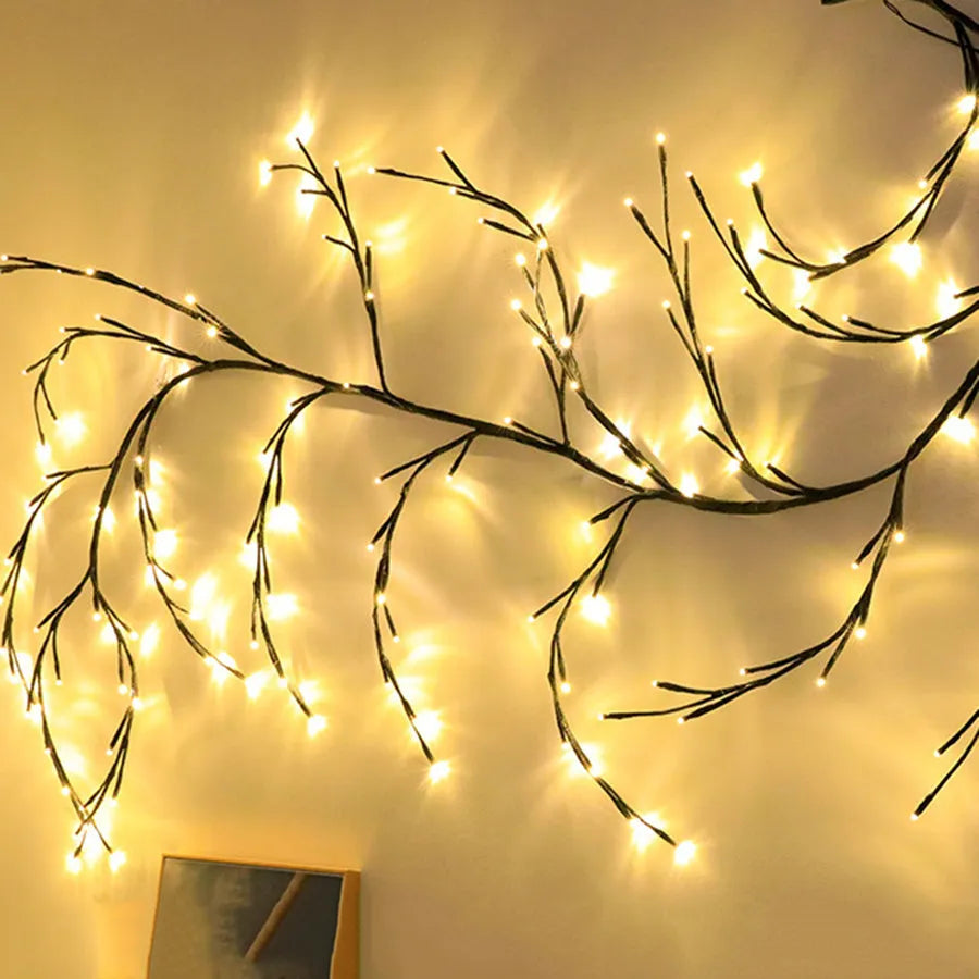 Flexible white birch LED vine light garland bent into decorative shape with warm white lights