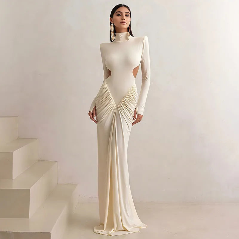 Women's light apricot high collar long sleeve pleated backless slim fit dress on a model.