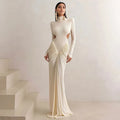 Women's light apricot high collar long sleeve pleated backless slim fit dress on a model.