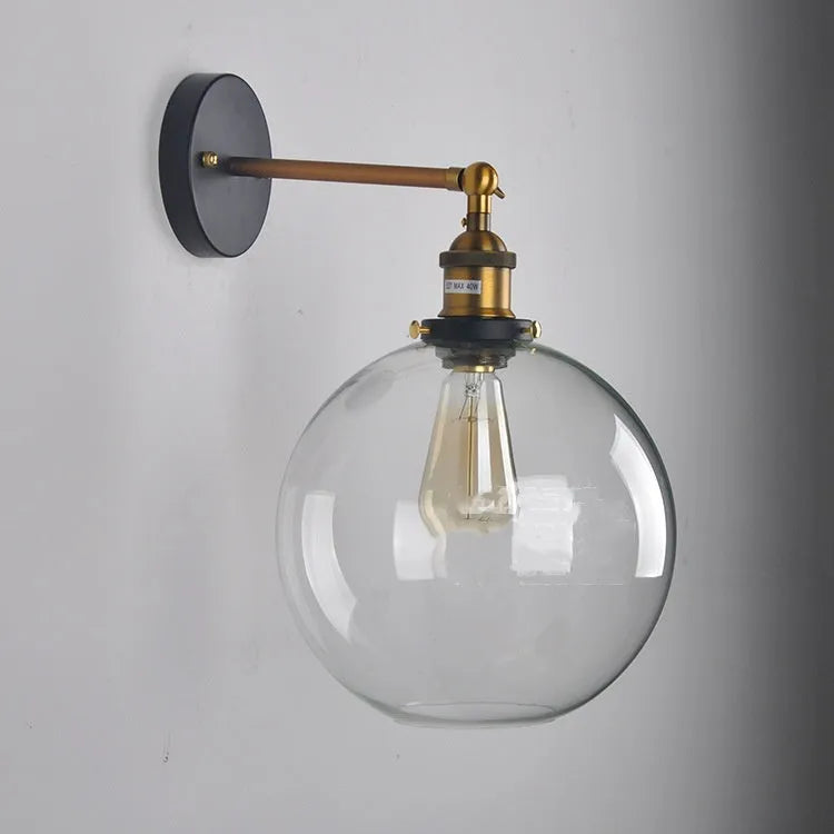 Round retro glass ball wall lamp in amber, smoke grey, or transparent finish with aluminium holder.