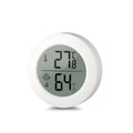 Round Smiling Face CX1030 digital temperature and humidity meter in white on a tabletop