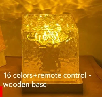 LED water ripple projection night light with remote control on wooden surface