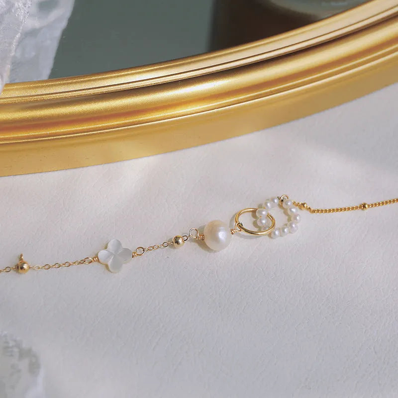 Women's natural pearl bracelet with gold-plated metal setting.