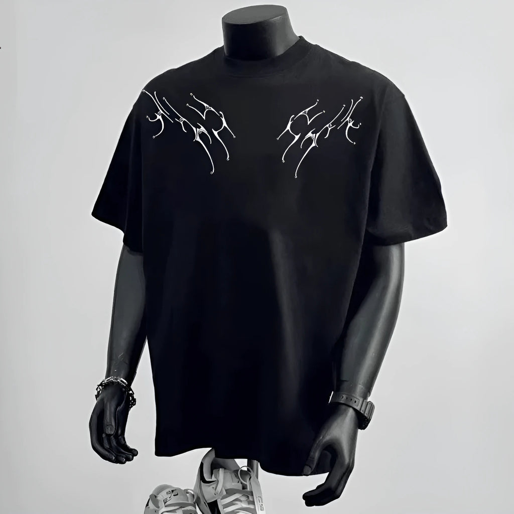 Man wearing a black loose fit pure cotton short sleeve tee shirt with a print design.