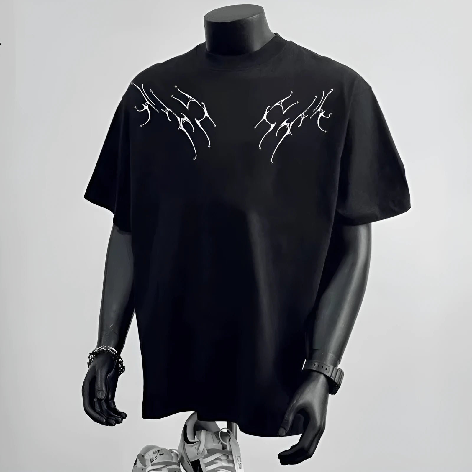 Man wearing a black loose fit pure cotton short sleeve tee shirt with a print design.