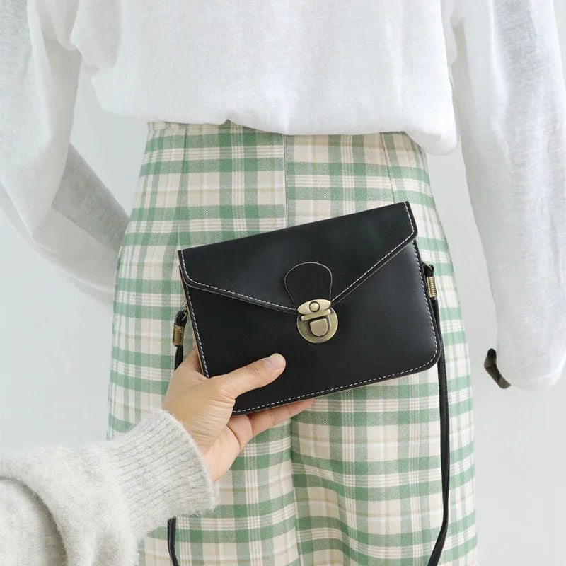 Retro soft surface messenger bag with crossbody strap and secure lock closure