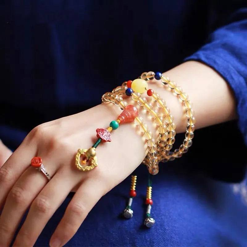 Yellow natural Brazilian citrine bracelet with 1mm beads and filament details on a wrist.