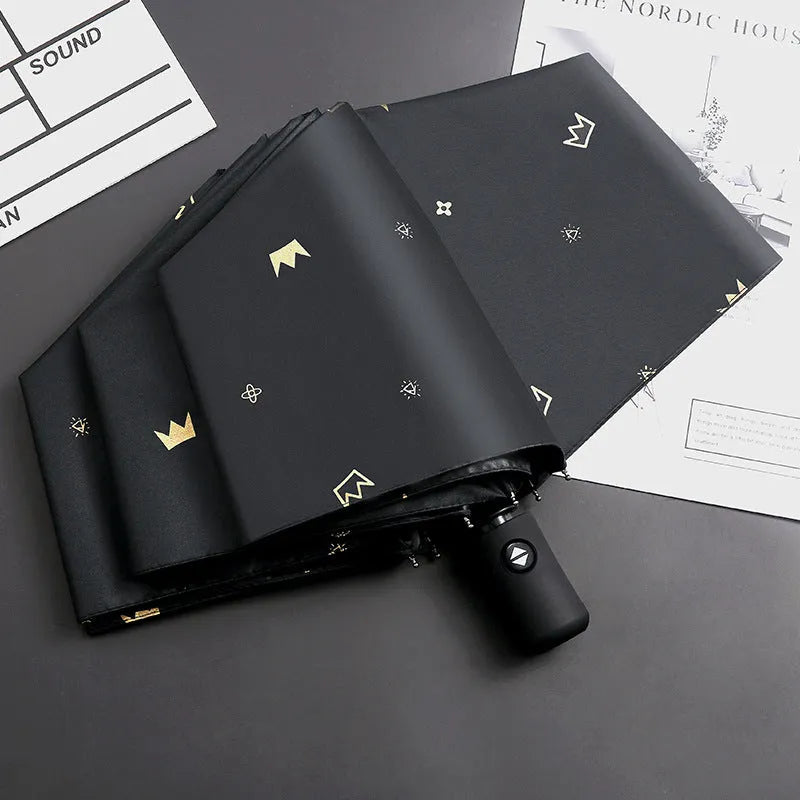Dual-use automatic eight-bone bronzing feather folding umbrella with black rubber handle and NC fabric canopy
