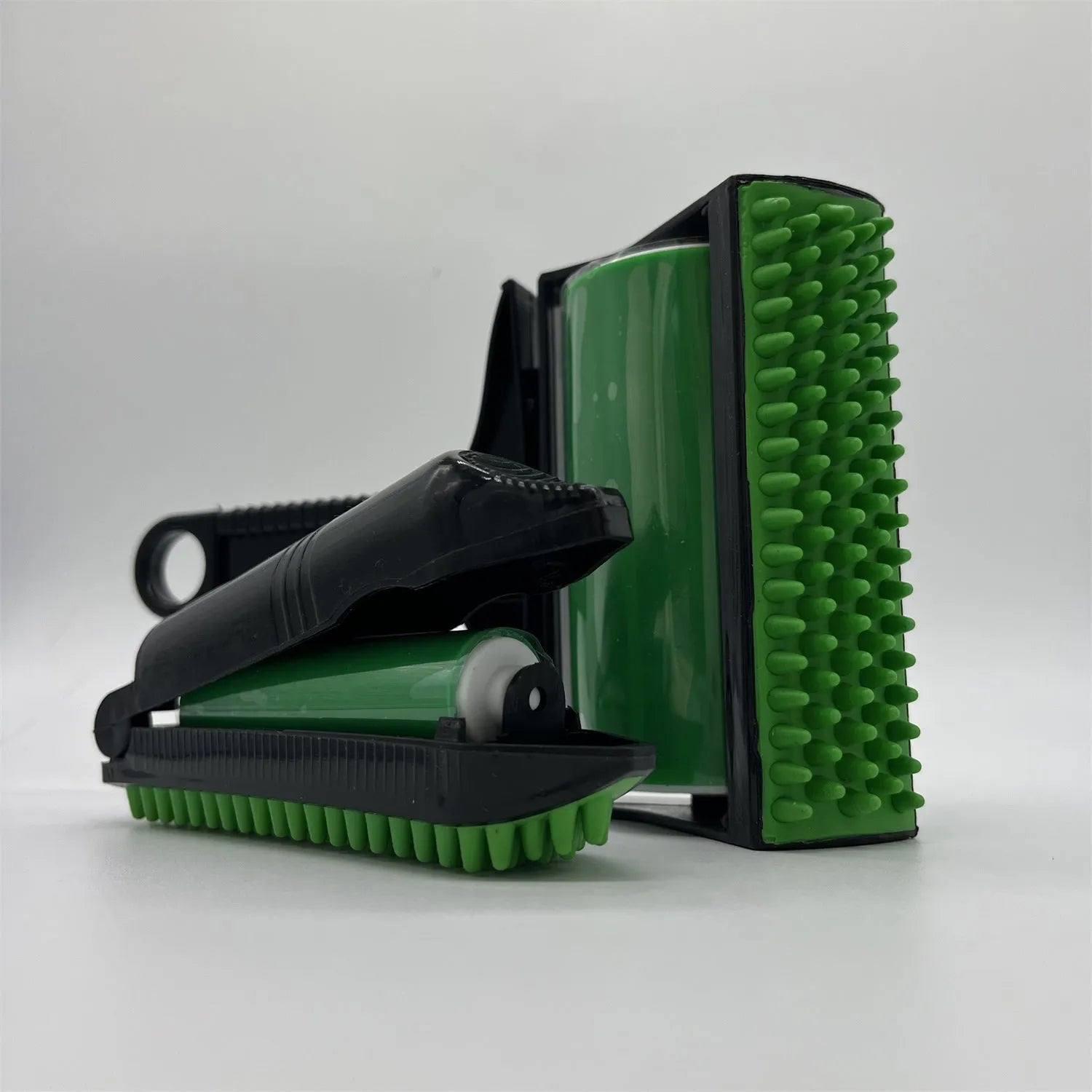 Yellow and green washable adhesive lint rollers for pet hair removal on a fabric sofa.