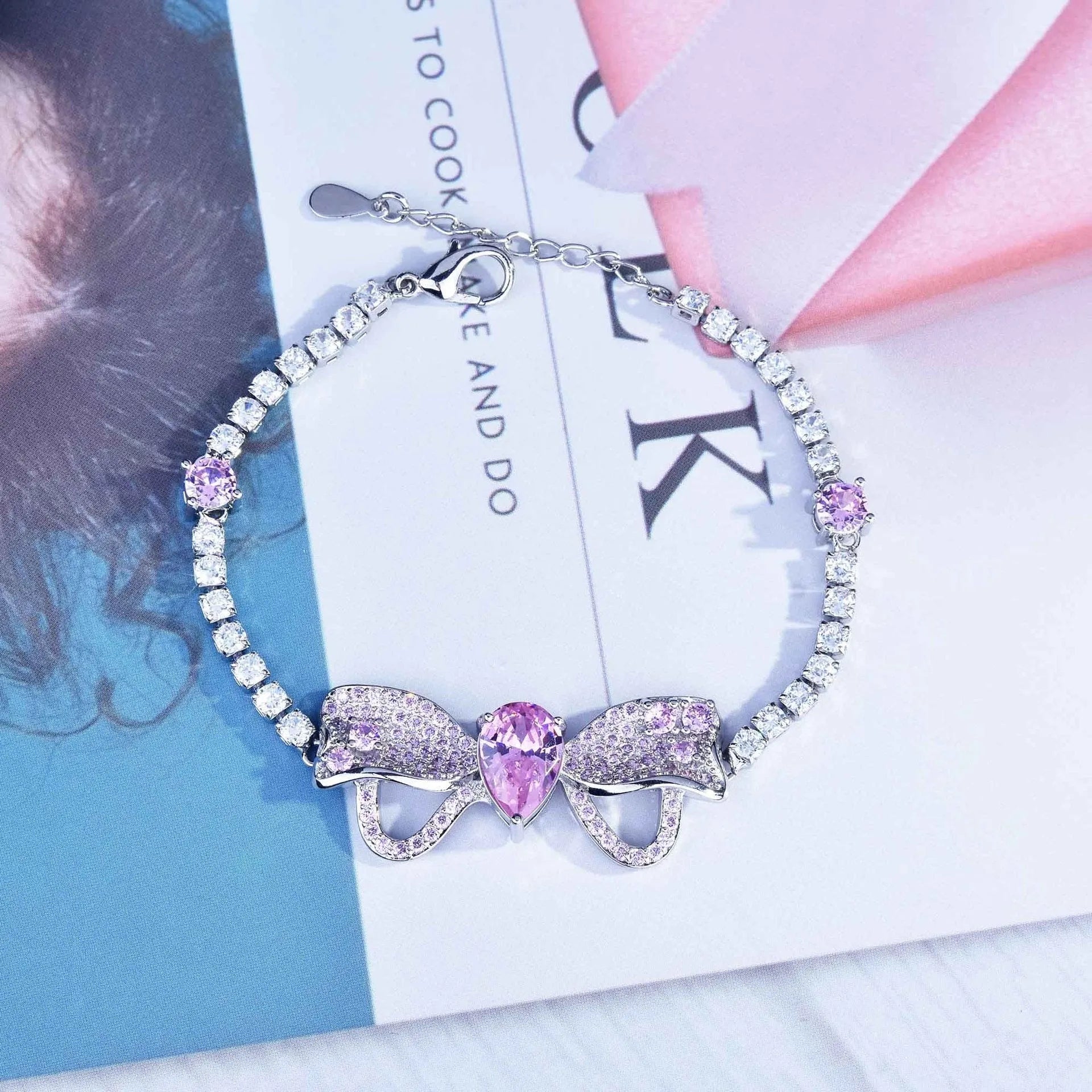 Full diamond bow jewellery set with necklace, bracelet, and ear studs in copper with mixed gem inlay