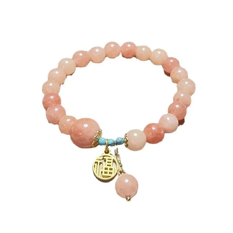 Women's pink natural stone bracelet with alloy metal setting and adjustable clasp
