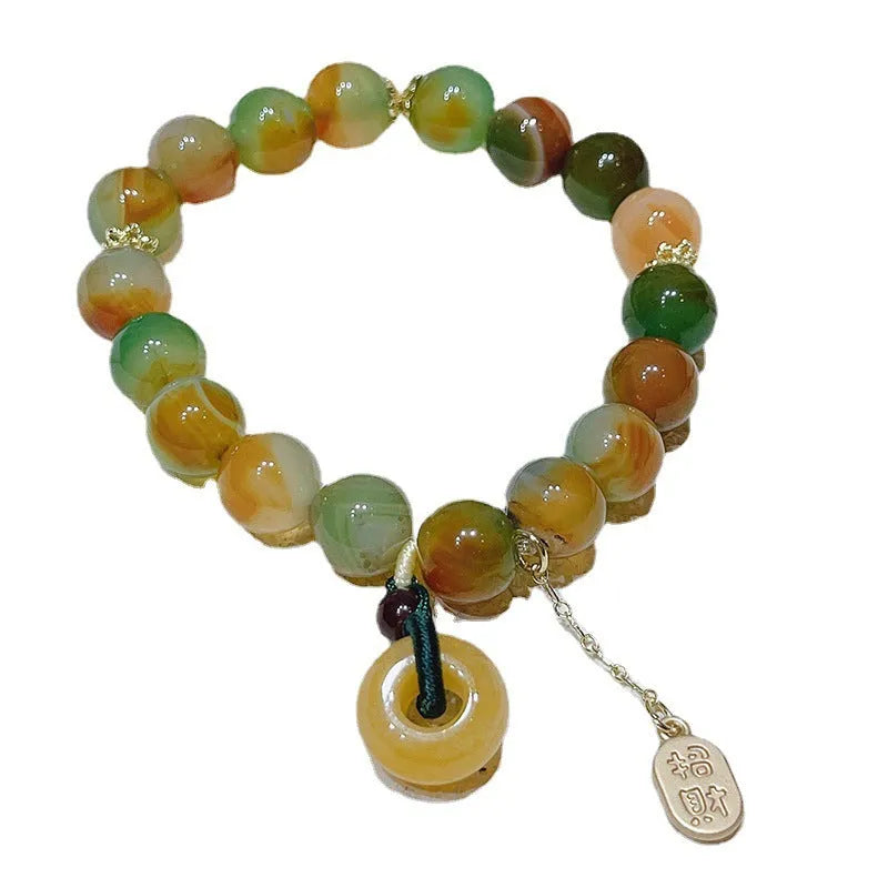 Yellow women's folk bracelet with peacock agate and topaz stones and a peace buckle clasp.