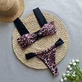 Black women's bikini with leopard print tube top and matching split T-back pant.