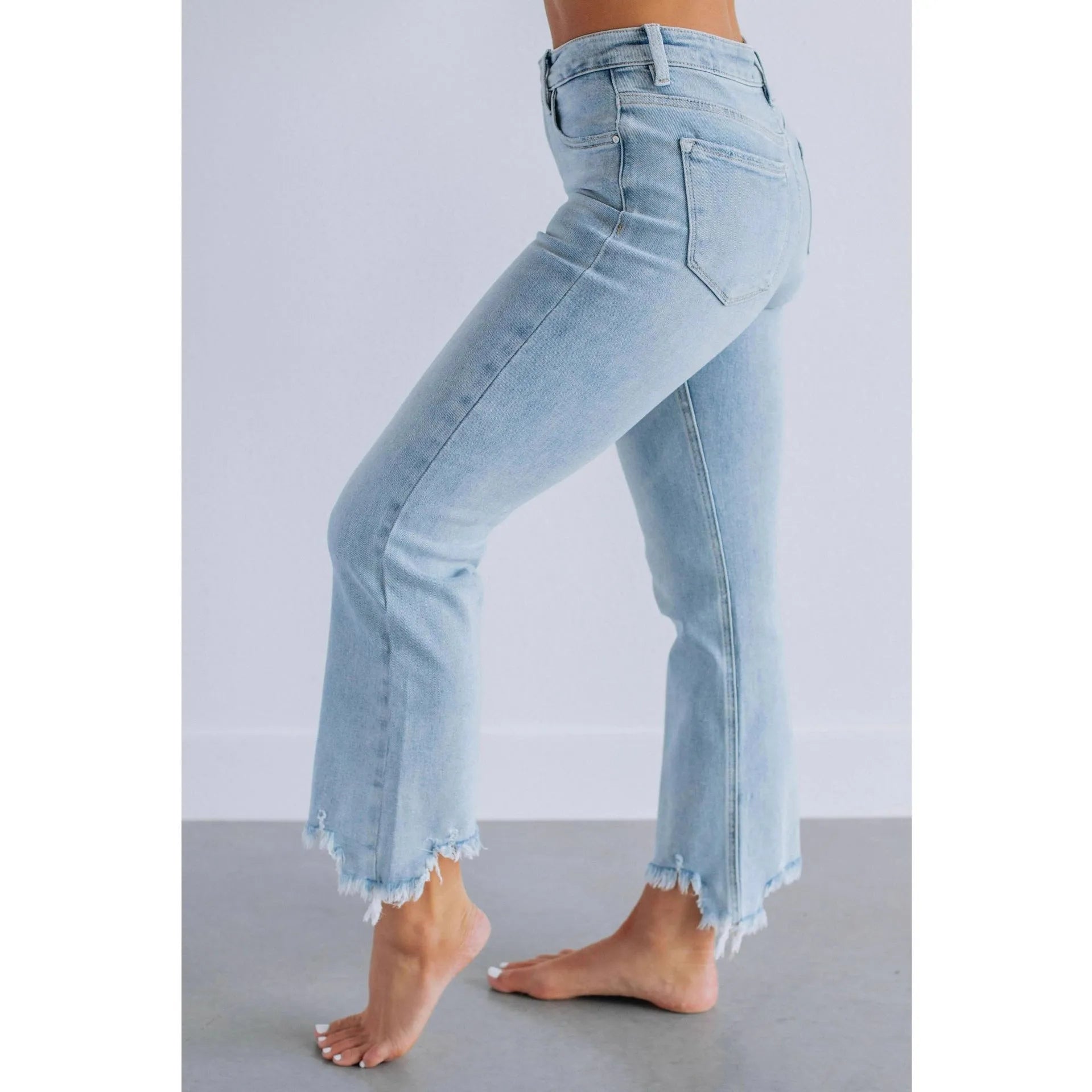 Women's solid colour denim jeans with a hand-worn distressed finish in dark blue.