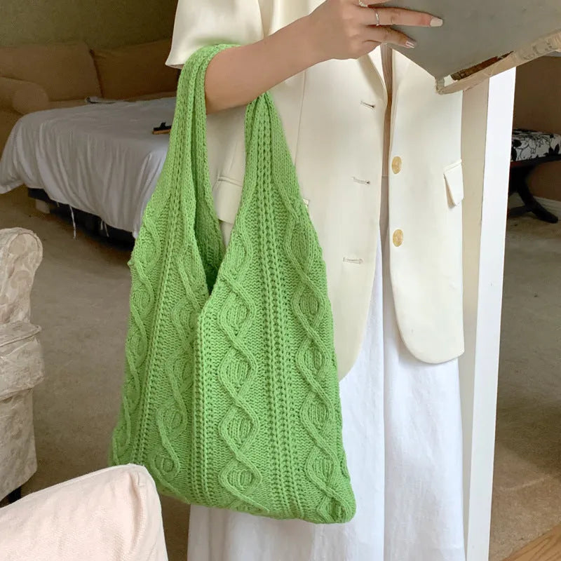 Retro hollow knitted woolen shoulder tote bag in a solid colour with double straps, shown flat displaying its large size.