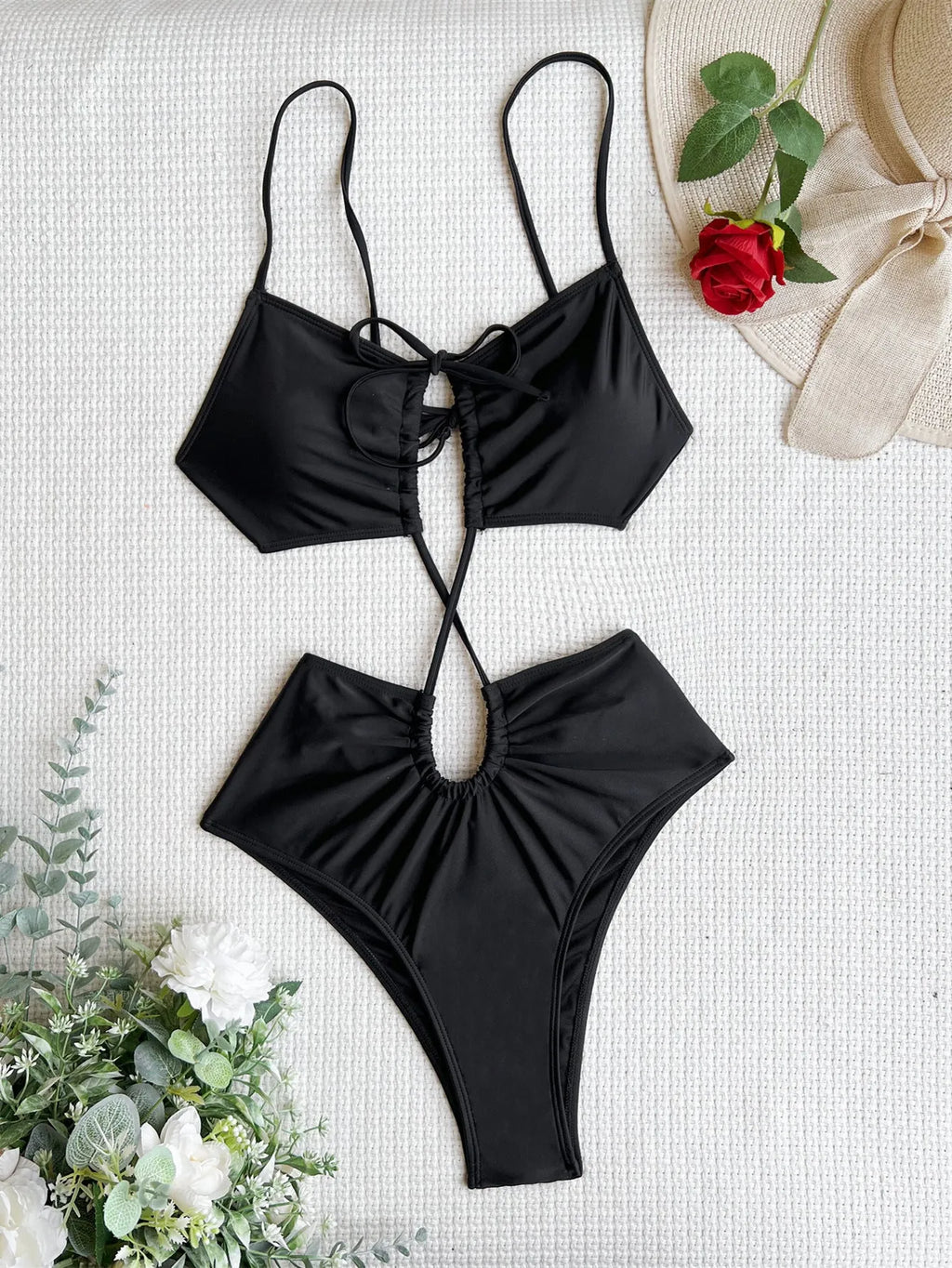 A woman's sleeveless one-piece swimsuit with a hollow back, shown in triangle style.