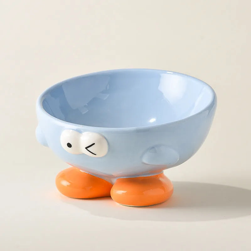 Blue tall ceramic pet food bowl with oblique shape and a silicone non-slip ring on the base.