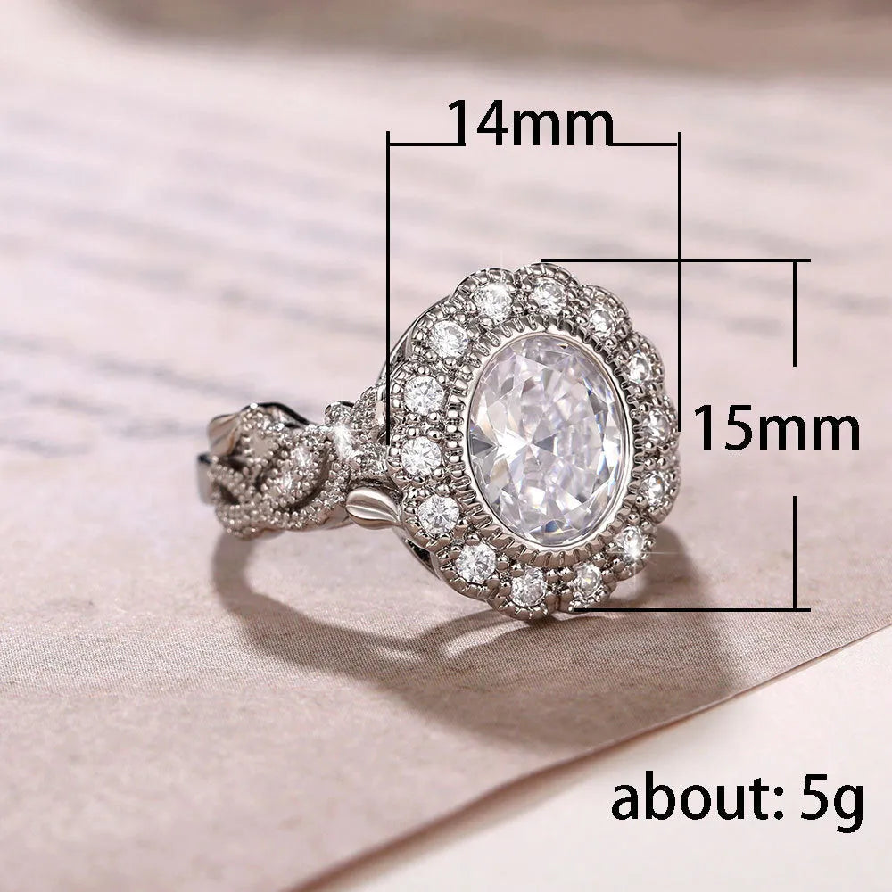 A geometric copper ring for women with a white gold coloured plating and a round zircon stone, shown on a finger.
